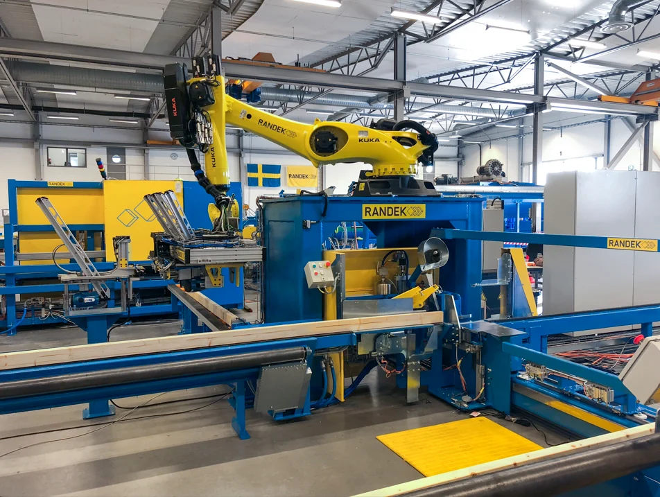 A robot feeding studs into a framing station
