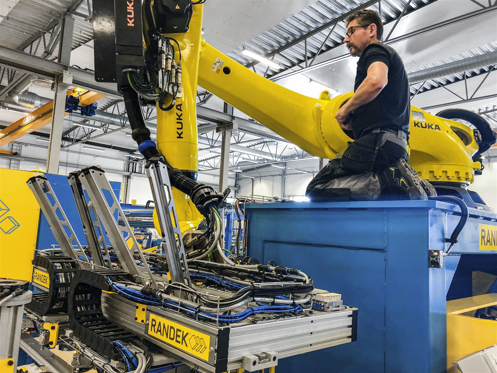 A Randek engineer working on a robot arm during build