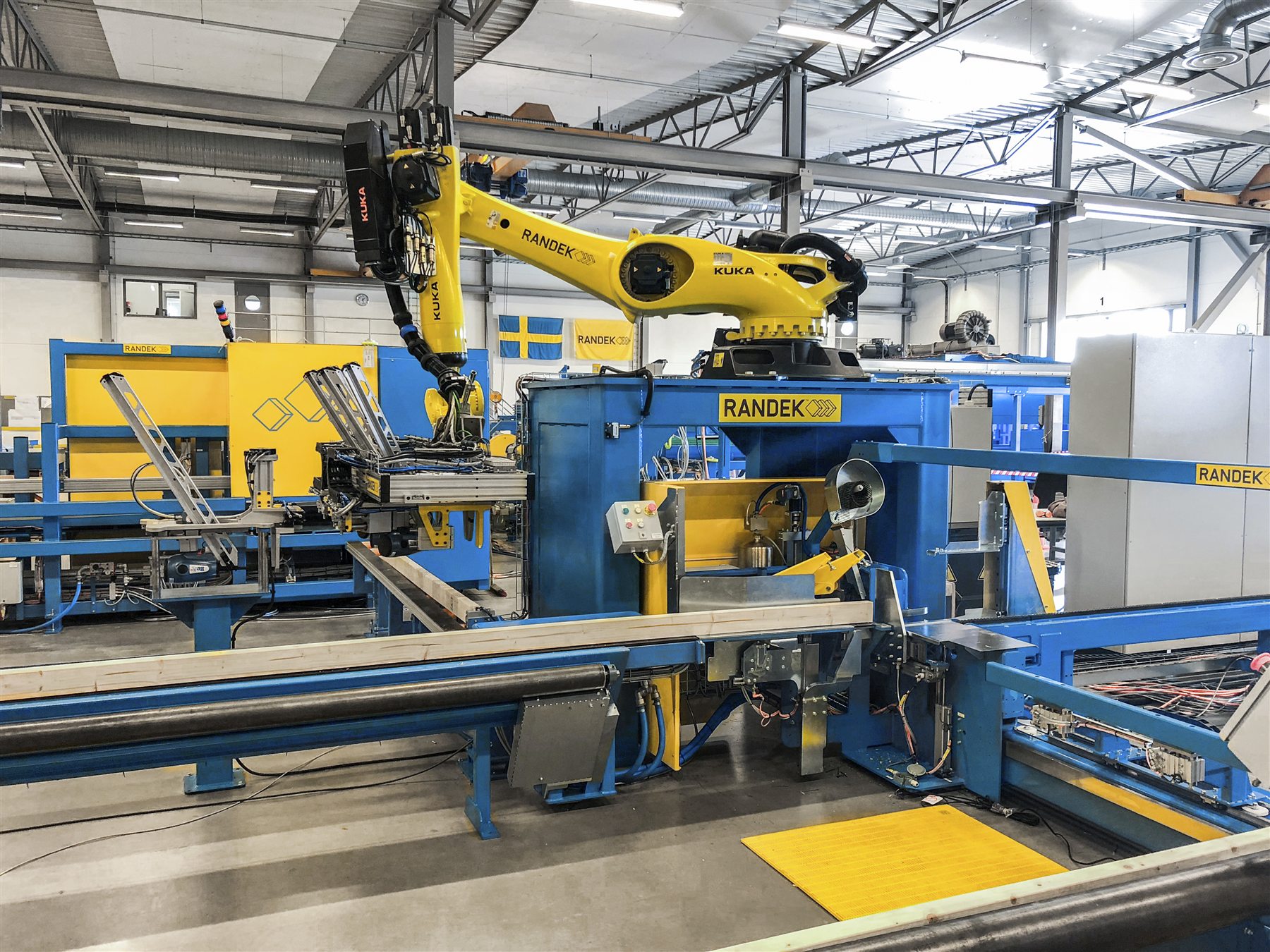 A Randek robotic cell under test at the plant in Sweden, Swedish flag on the wall