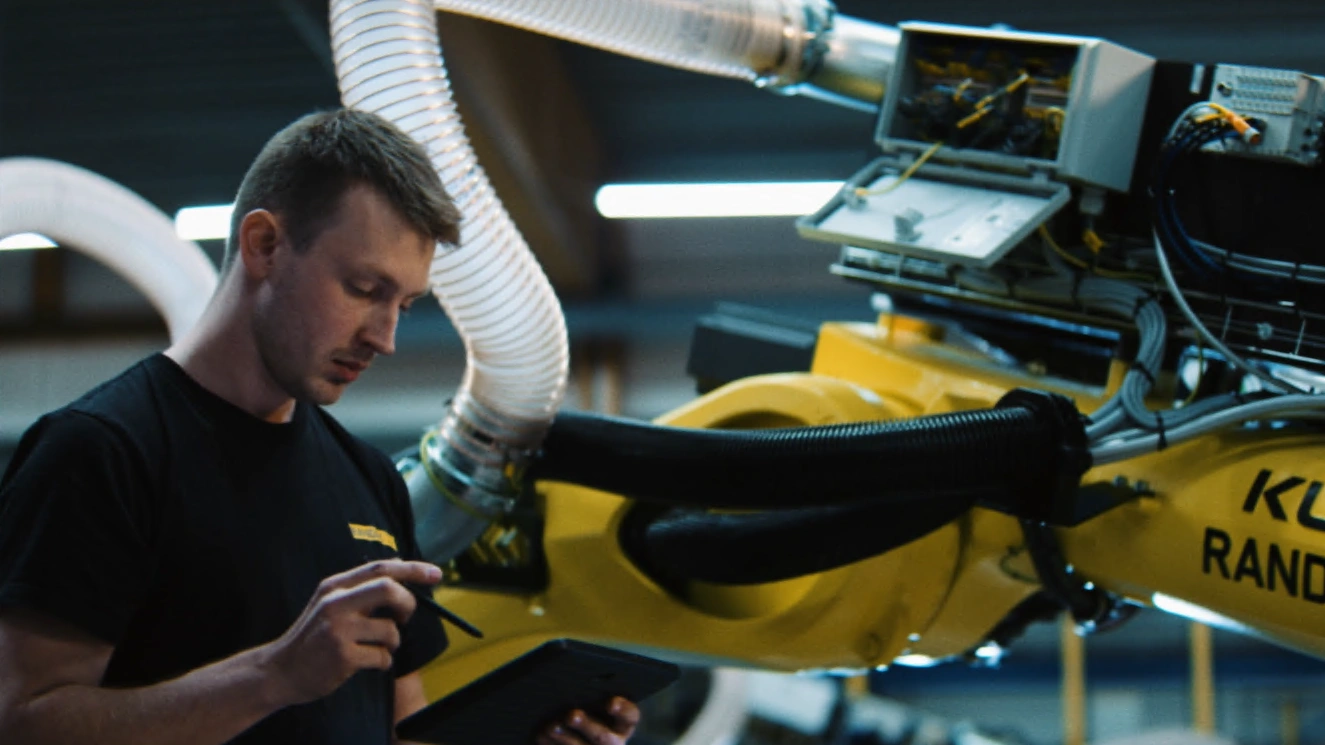 A Randek technician servicing a robot cell on the line
