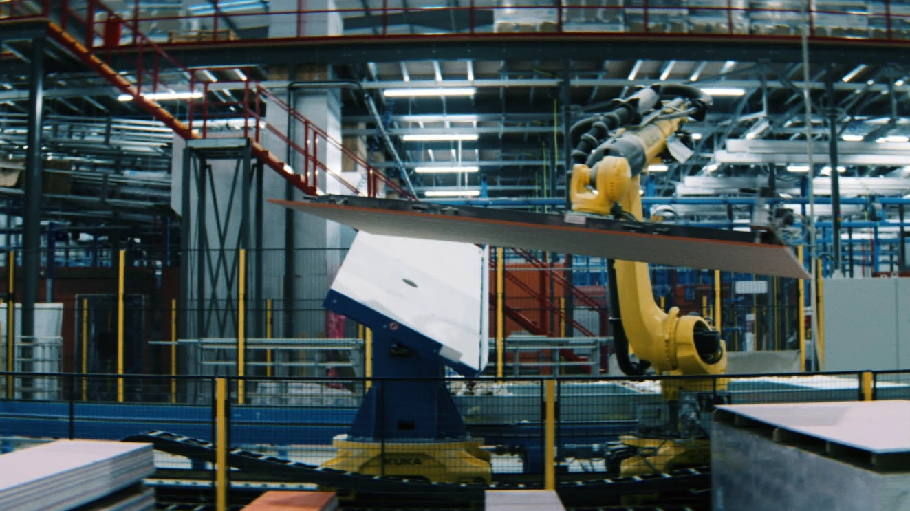 A Randek robot lifting a sheathing board on the line